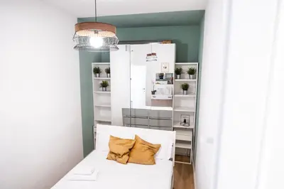 a room with a white couch with two pillows on it at Apartment by the Colosseum - White Chic Flats in Rome
