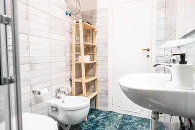 a bathroom with a toilet and a sink at Apartment by the Colosseum - White Chic Flats in Rome