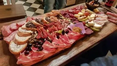 a board with meat and other foods on a table at Campo24roma Guesthouse in Rome