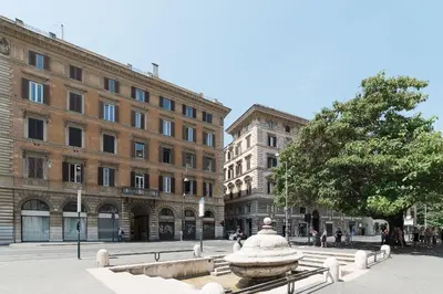a city square with a fountain in front of buildings at Loft Farnese 1 suite luxury area soggiorno e cucina in Rome