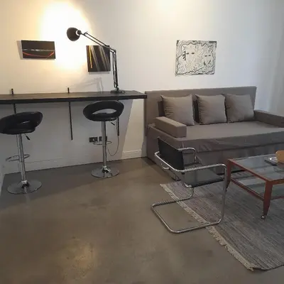a living room with a couch and a table at Loft Farnese 1 suite luxury area soggiorno e cucina in Rome