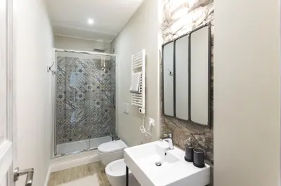 a bathroom with a toilet sink and a shower at Casa di Ele in Rome