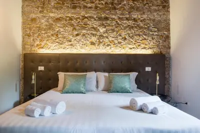 a bedroom with a large bed with towels on it at Beyond Colosseum in Rome