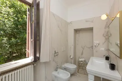 a bathroom with a shower and a toilet and a sink at Beyond Colosseum in Rome