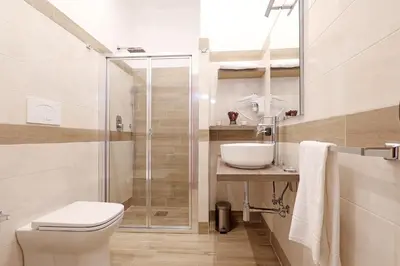 a bathroom with a shower and a toilet and a sink at Olafo’s house in Rome