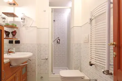 a bathroom with a shower and a toilet and a sink at Olafo’s house in Rome