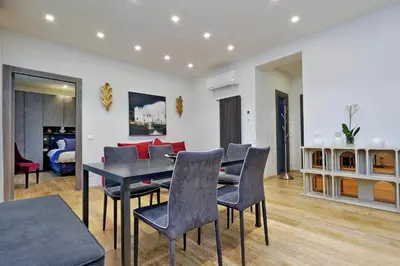 a dining room with a table and chairs and a couch at Houses&HousesVEDOROMA in Rome