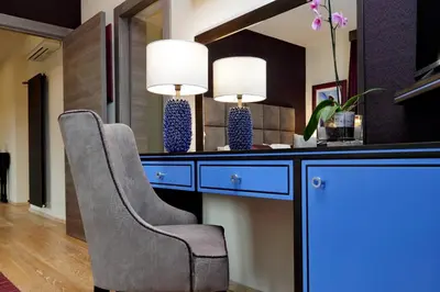 a room with two chairs and a desk with two lamps at Houses&HousesVEDOROMA in Rome