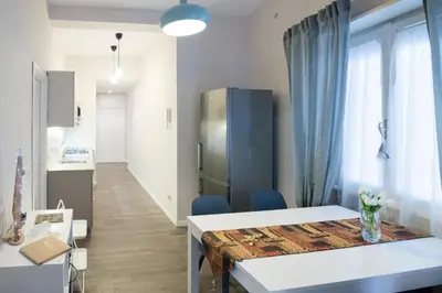 a small room with a table and a refrigerator at La RomAntica Roma in Rome