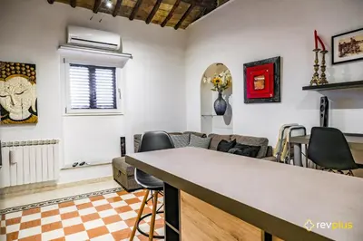 a living room with a table and chairs at Cozy flat in Rome in Rome