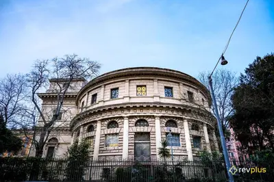 a large stone building with a clock on it at Cozy flat in Rome in Rome