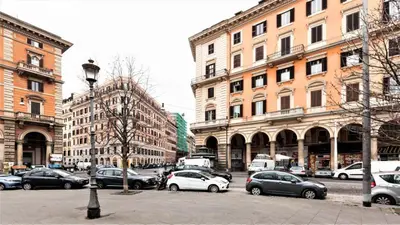 a city street with cars parked in front of buildings at Cozy flat in Rome in Rome