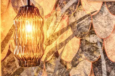 a gold lamp hanging from a wall with a painting at Maison d'Art Apartments - Maison d'Art Collection in Rome