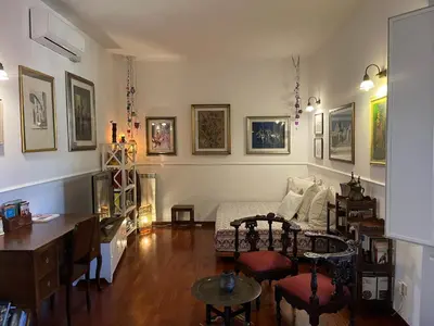 a living room with a bed and a desk at House Candia 111 - Vatican Museum apartment in Rome