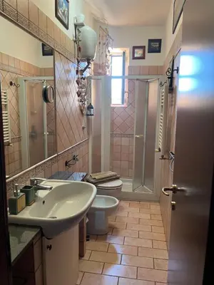 a bathroom with a sink and a toilet and a shower at House Candia 111 - Vatican Museum apartment in Rome