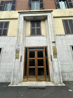 a building with a door in the middle of a street at B&B Una notte a Mazzini in Rome