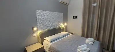 a bedroom with a bed with two towels on it at MCM in Rome