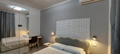 a small room with a bed and a mirror at MCM in Rome