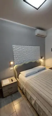a bedroom with a large bed and a table at MCM in Rome