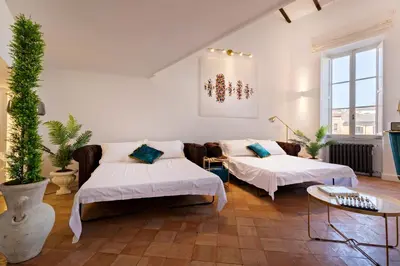 a living room with two beds and a couch at Presidential Penthouse Navona in Rome