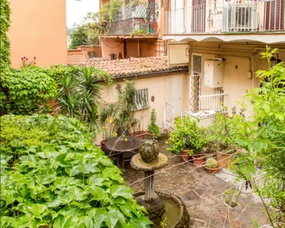 an outdoor garden with plants and a building at Charming Studio near the Colosseum in Rome, 45 m² with Balcony in Rome