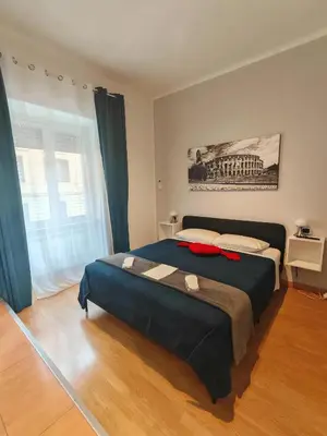 a bedroom with a large bed with a blue blanket at AD Trastevere Guest House - by AD Roma in Rome