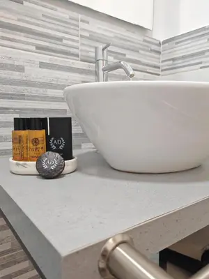 a bathroom counter with a sink and a book at AD Trastevere Guest House - by AD Roma in Rome