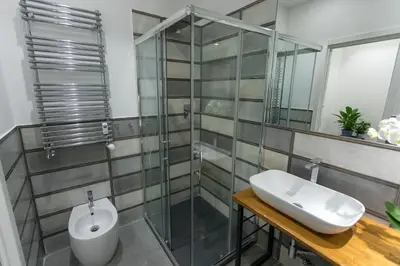 a bathroom with a glass shower and a sink at Testaccio historic house in Rome