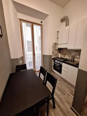a kitchen with a table and chairs in a room at Vatican Tolemaide 2 in Rome