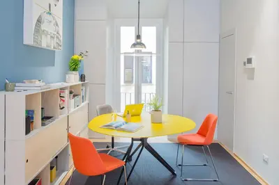 a dining room with a yellow table and orange chairs at The Radical Hotel Roma in Rome