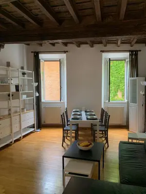 a living room with a table and chairs at Navona Relais - Center of Rome in Rome