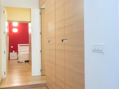 a room with a wooden door and a bedroom at Spagna Sistina 143 in Rome