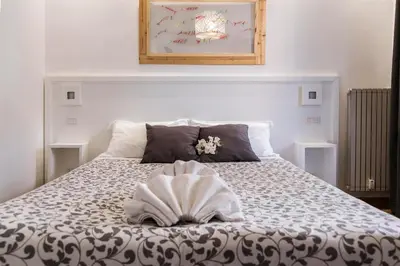 a bedroom with a bed with a book on it at Dulcis In Vatican b&b in Rome
