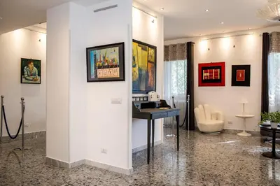 a room with a desk and paintings on the wall at Dulcis In Vatican b&b in Rome