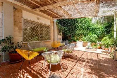 a patio with chairs and tables on a patio at St. Peter Garden House in Rome