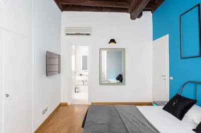 a bedroom with a bed and a mirror at A World Aparts - 87 Boschetto in Rome