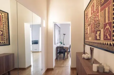 a room with a hallway with a dining room at A World Aparts - 87 Boschetto in Rome