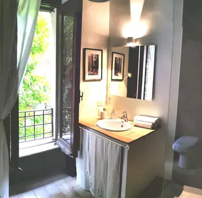 a bathroom with a sink and a mirror and a window at Casa Nora in Rome