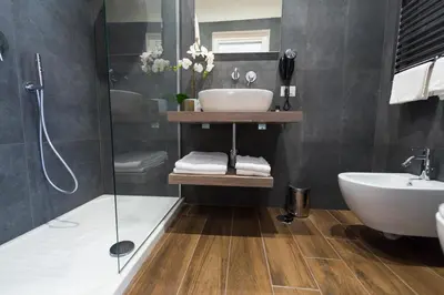 a bathroom with a sink and a shower at Rent Rooms Trastevere in Rome