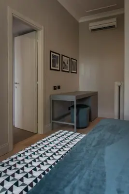 a room with a table and a table and a bed at Domus Alberico in Rome