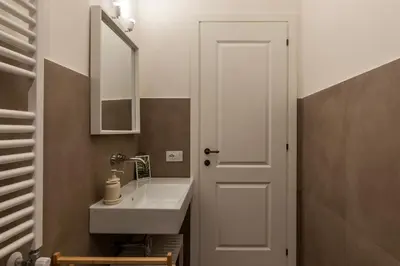 a bathroom with a sink and a mirror at CS Termini Nazionale Apartments in Rome