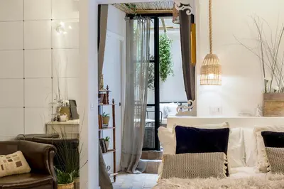 a living room with a couch and a chair at Trastevere Gem Cozy Light-filled Retreat in Rome