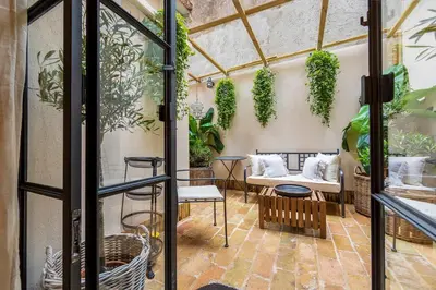 an indoor garden with plants in a greenhouse at Trastevere Gem Cozy Light-filled Retreat in Rome