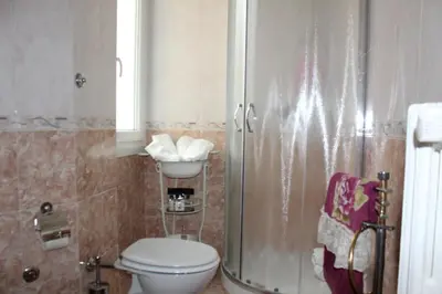 a bathroom with a toilet and a shower and a sink at ART APARTMENT VILLA FIORELLI in Rome