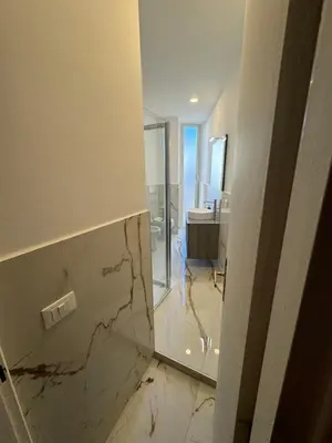 a bathroom with a marble floor and a mirror at Rome Luxury House - The House in Rome