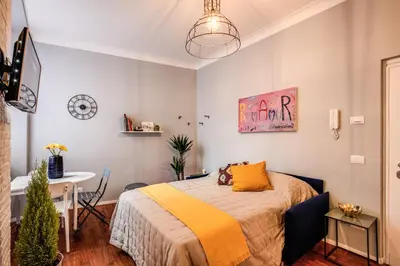 a bedroom with a bed and a table in a room at Capo Le Case Home 9 in Rome
