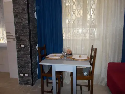 a table with chairs and a white table and a window at Milla's house rome in Rome