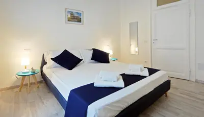 a bedroom with a bed with two towels on it at Pompeo Magno White Luxury Apartment in Rome