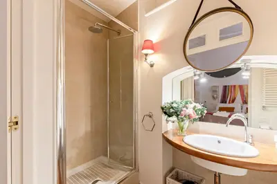a bathroom with a shower and a sink and a mirror at Rome As You Feel - Cancelli Apartment in Rome