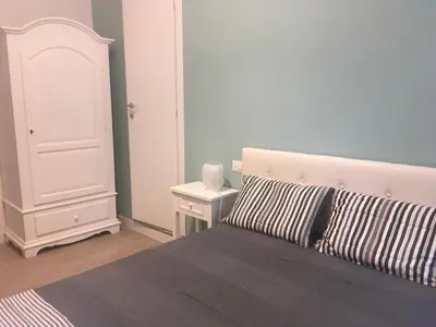 a bedroom with a bed and a white cabinet at Vatican Room and Kitchen in Rome